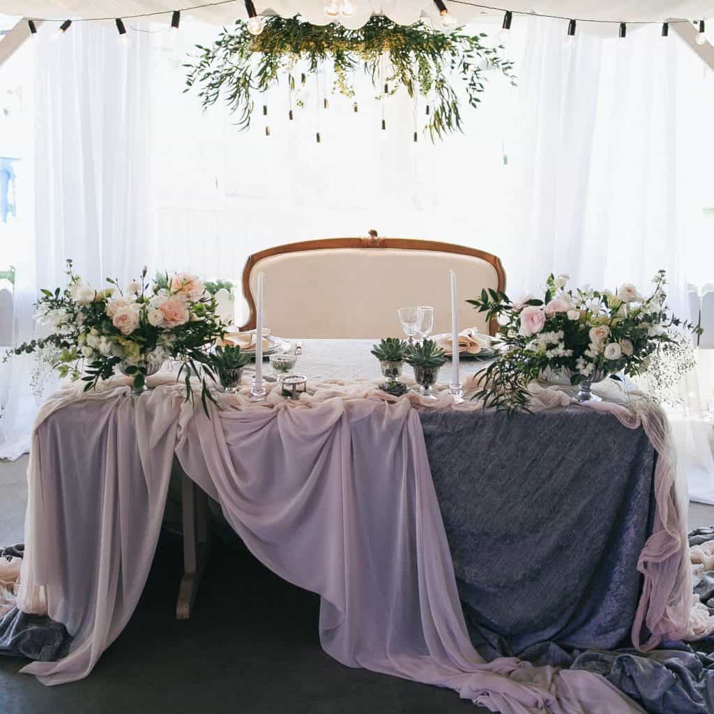 beautiful decorated table with flowers and candles at wedding reception