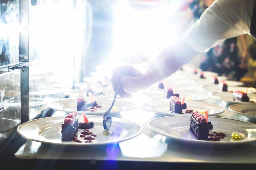 Caterer serving desserts in restaurant