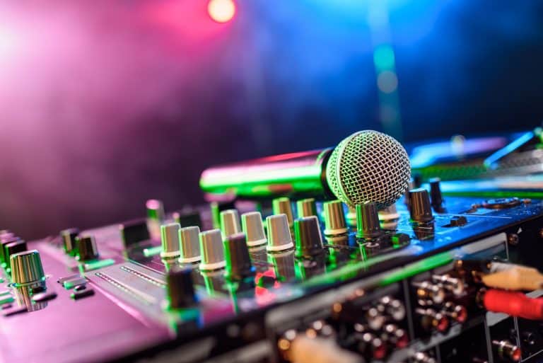 close up view of sound mixer with microphone in nightclub